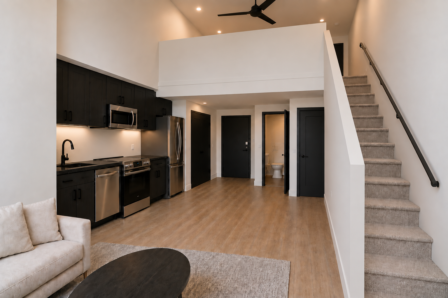 Two-level loft residence with open kitchen, wood floors, and a stair to the loft above